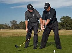 Golf instructor giving a one-on-one lesson
